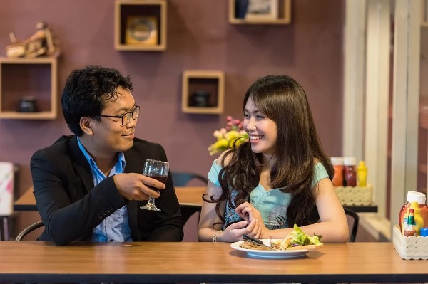 Conversación pareja en restaurante con plato servido